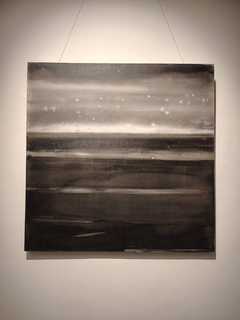 Abstract monochrome painting depicting a textured landscape with varying shades of black, gray, and white, featuring subtle highlights resembling distant stars.