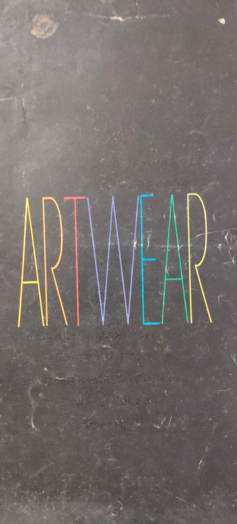 The word 'ARTWEAR' displayed in colorful, stylized letters against a dark background.