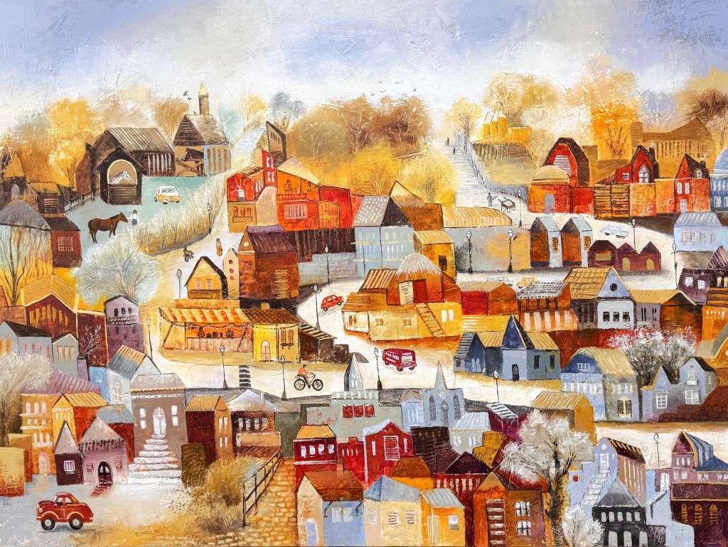 A vibrant, colorful painting of a quaint village with various houses and buildings in shades of red, orange, and blue. There are trees, pathways, and small vehicles, including a bicycle and a red car. The scene is filled with autumn hues, suggesting a warm, inviting atmosphere.